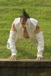 a man in a white outfit is doing push ups on a wall
