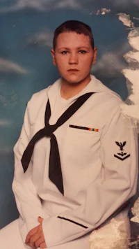 a sailor in uniform posing for a photo