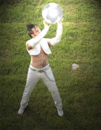 a man holding a silver ball in his hands