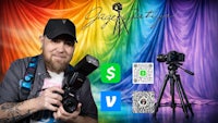 a man holding a camera and a tripod in front of a colorful backdrop