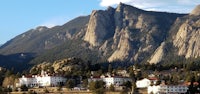a large white building in front of a mountain
